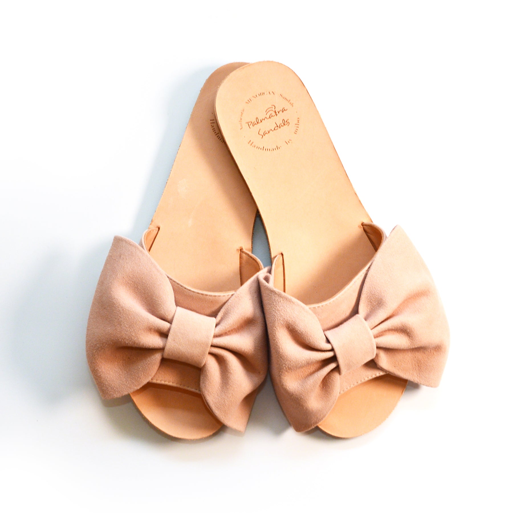 nude pink suede flat sandals with oversized bow sliders
