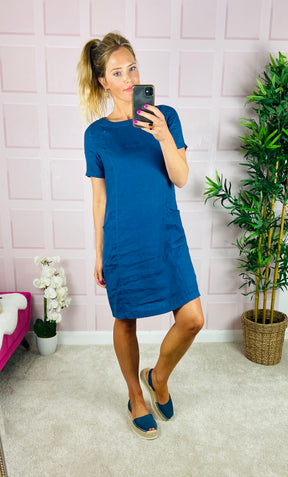 Classic linen slip-on dress in mid blue, with short sleeves and pockets.