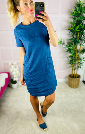 Classic linen slip-on dress in mid blue, with short sleeves and pockets.