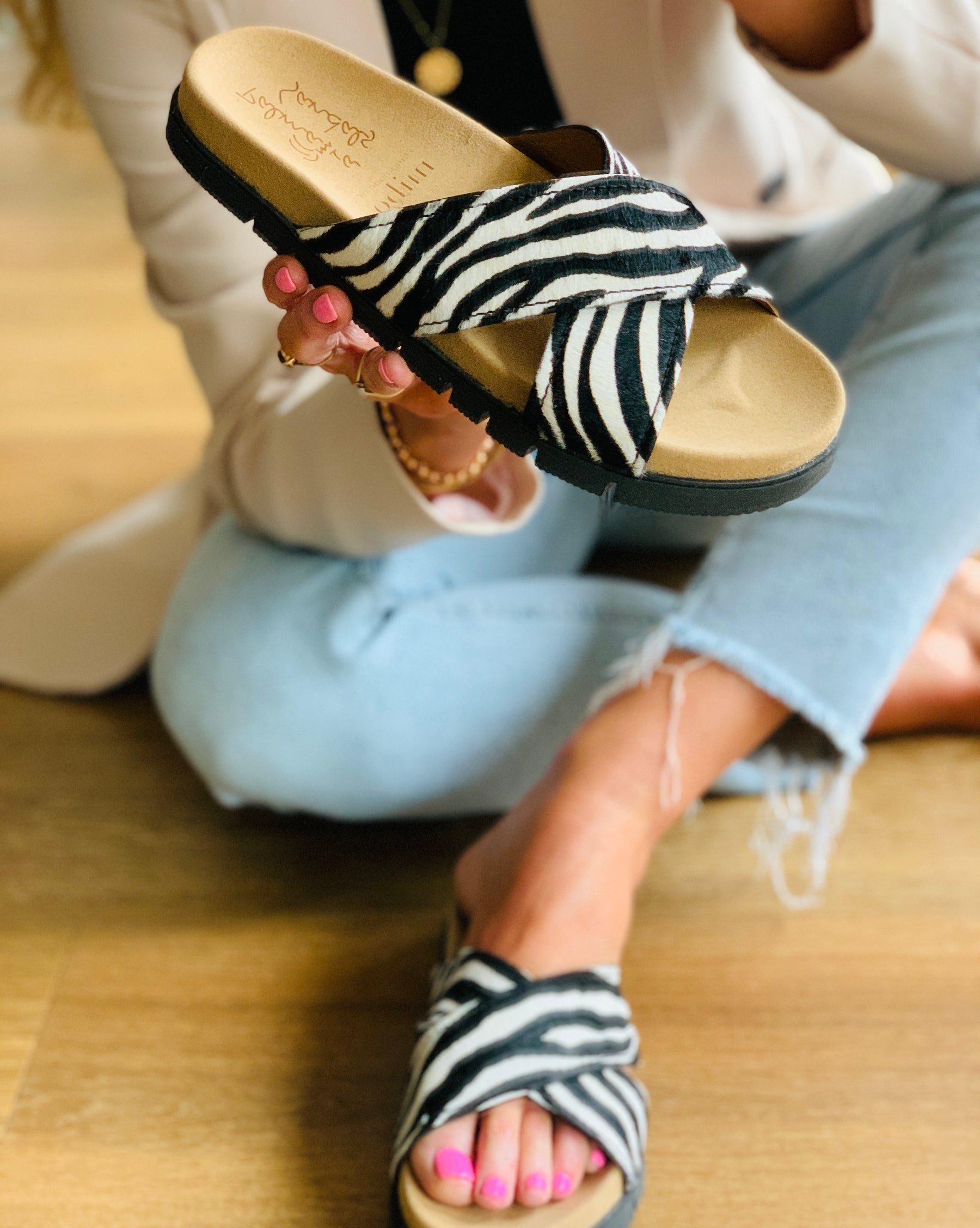 zebra print hair-on leather crossover slide with an ergonomic sole for added arch support