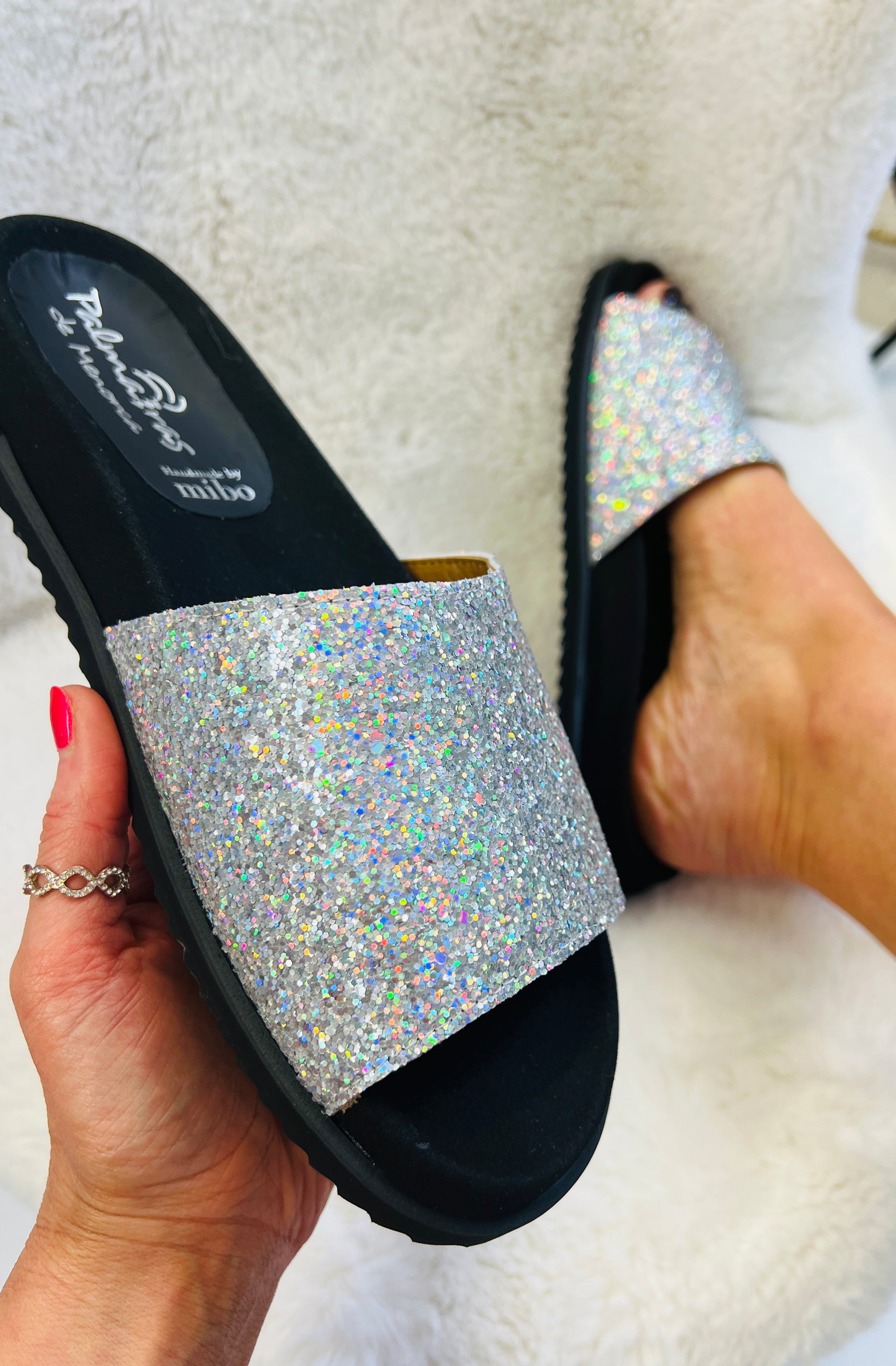 Slip on, silver sparkly sliders with an ergonomic microsuede innersole