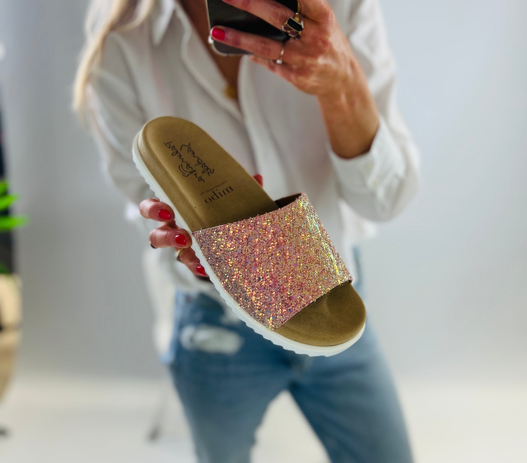 Slip on, peachy pink sparkly sliders with an ergonomic microsuede innersole