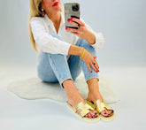 Slip on, gold leather sliders with an ergonomic gold innersole