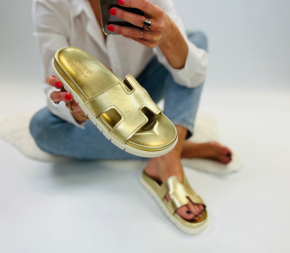 Slip on, gold leather sliders with an ergonomic gold innersole