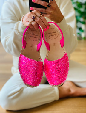 Bright neon pink glitter upper on a traditional menorcan avarca with a neon pink napa leather slingback heelstrap and flexible rubber sole.