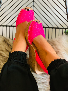 Bright pink glitter upper on an 8cm mid height cork wedge with neon pink napa leather slingback heelstrap