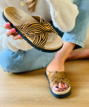 tiger print hair on leather crossover slide sandals on an ergonomic sole with arch support 